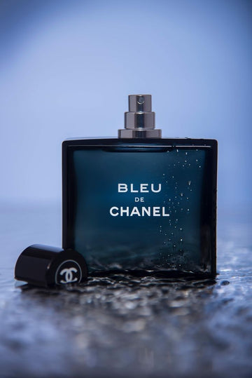 Bleu de Chanel perfume bottle with sophisticated cityscapes and elegant masculine style background