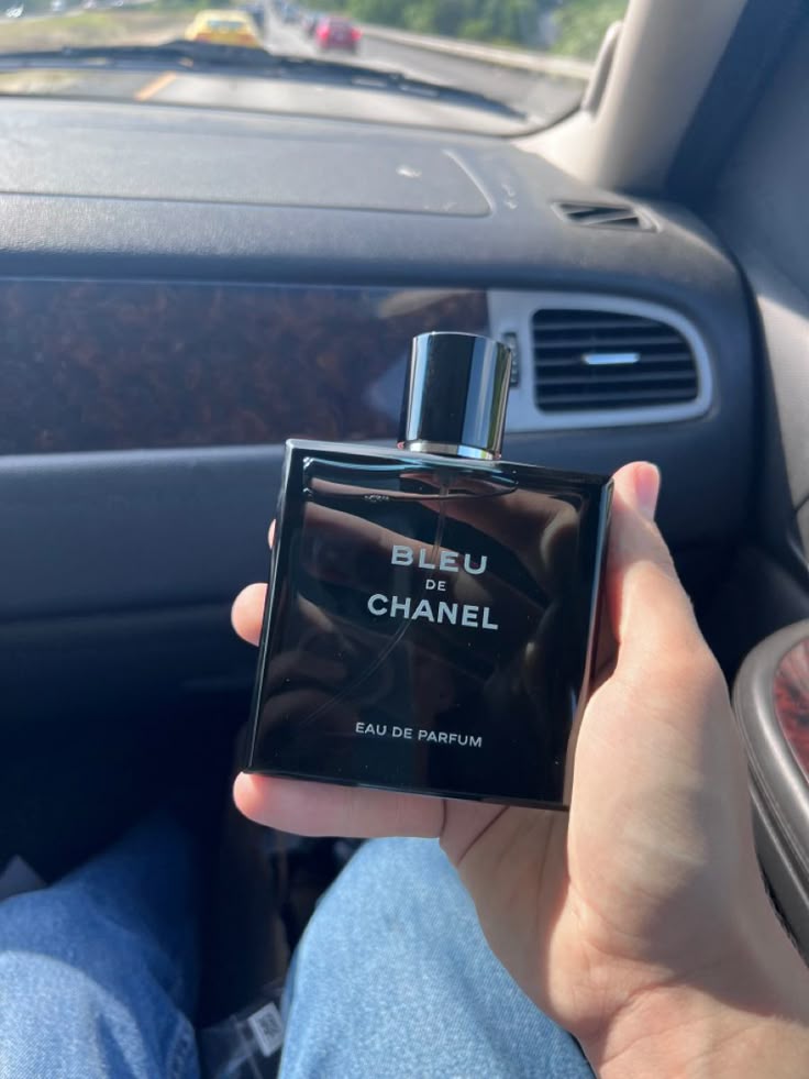 Bleu de Chanel perfume bottle with sophisticated cityscapes and elegant masculine style background